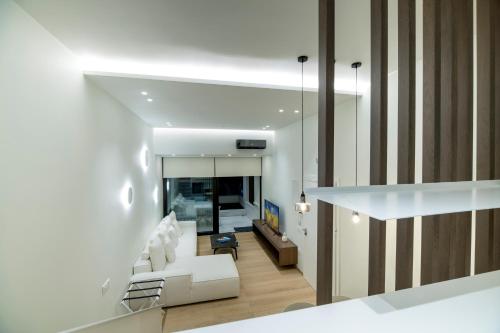 a living room with a white couch and a table at GM exclusive Luxury Suites & SPA in Sitia