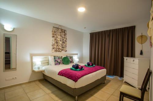 Cama o camas de una habitación en Palapa Beach Paradise