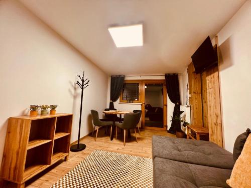a living room with a couch and a table at Apartment für 2 Erwachsene und 2 Kinder mit Weinkeller und kleinem Hof mit Frühstück - Self made in Retz