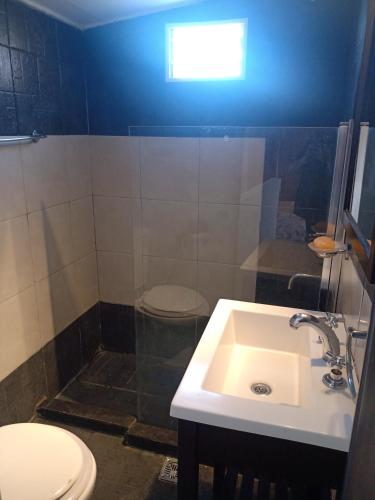 a bathroom with a sink and a toilet at Departamento dos ambientes Belgrano R in Buenos Aires