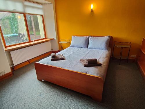 a bedroom with a bed with two towels on it at The Mill Lade - Hidden House in Arbroath