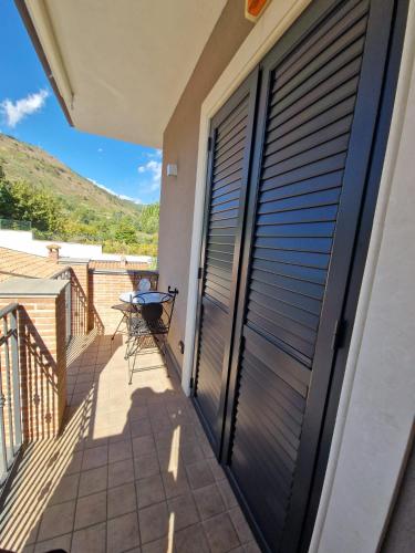 a view from the balcony of a house with a sliding door at Bedda Mia Etna House B&B in Trecastagni