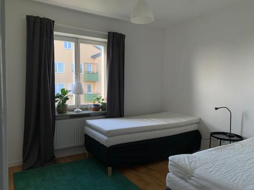 a bedroom with a bed and a window at Home Inn SLV4 in Stockholm