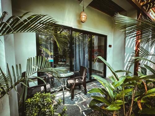 a patio with a table and chairs and plants at Villa Eden Palomino in Palomino