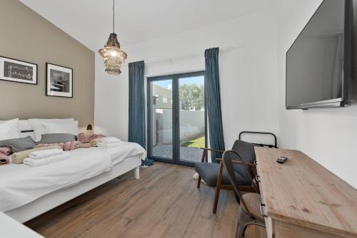 a bedroom with a large bed and a wooden table at Villa Stellar in Brtonigla