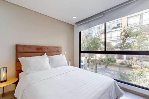 Voodi või voodid majutusasutuse Acogedor Apartamento Cozy Chico Norte toas