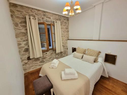 a bedroom with a bed and a table and a window at Casa Rural Betraunea in Sumbilla