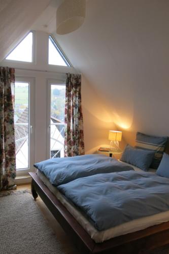 a bedroom with a bed and a large window at Ferienhaus Julius in Willingen