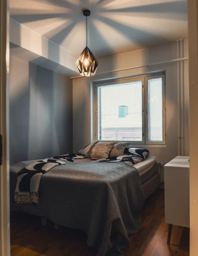 a bedroom with a bed and a window at Aurora Breeze Residence - City Center in Rovaniemi