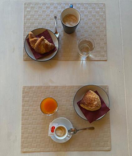 a table with two plates of food and a cup of coffee at Dolce Farinella in Putignano
