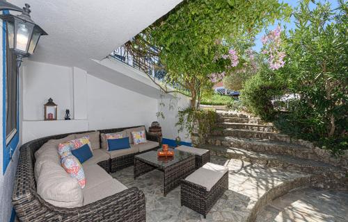 a patio with a couch and a table and trees at Quinta de São Pedro in Sobreda