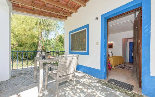 a patio with a table and a door to a bedroom at Quinta de São Pedro in Sobreda