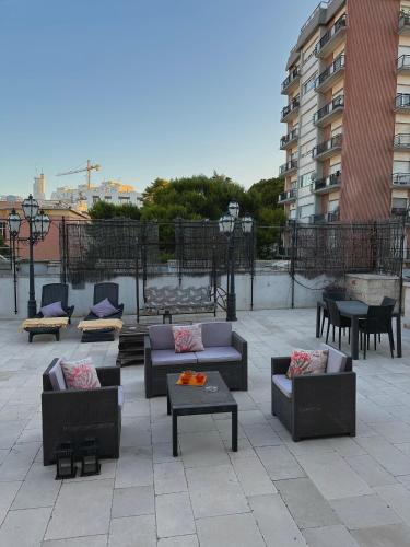 a patio with couches and tables on a building at Dolce Farinella in Putignano