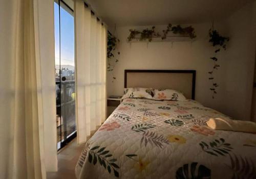 a bedroom with a bed and a large window at Big apartment near historical center in Arequipa