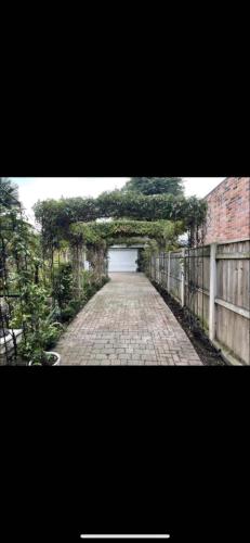 a brick road with a fence and a white garage at Roseberry Loft perfect for Wilton site in Nunthorpe