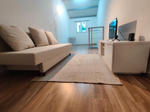 a living room with a couch and a rug at Azores Square House historic city center in Ponta Delgada