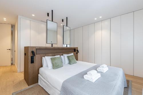 a bedroom with a bed with two towels on it at BNBHolder Luxury II SOL in Madrid