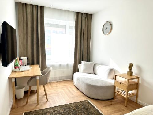 a living room with a couch and a table at MIRABELLE Homes in Salzburg