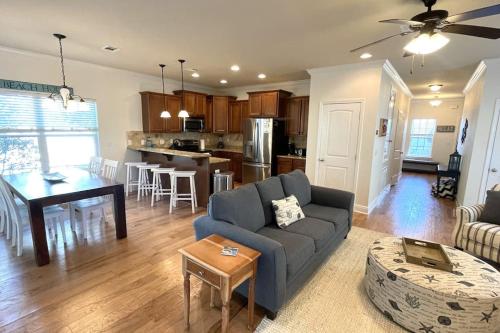 a living room and kitchen with a couch and a table at Grayling Beach House in Inlet Beach