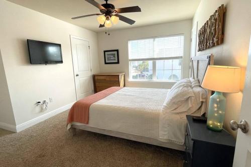 a bedroom with a bed and a ceiling fan at Grayling Beach House in Inlet Beach