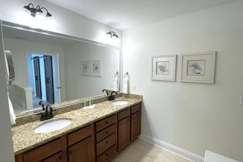 a bathroom with two sinks and a large mirror at Grayling Beach House in Inlet Beach
