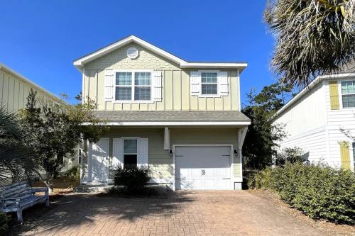 a white house with a garage and a driveway at Grayling Beach House in Inlet Beach