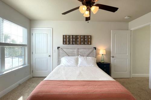 a bedroom with a bed with a ceiling fan at Grayling Beach House in Inlet Beach