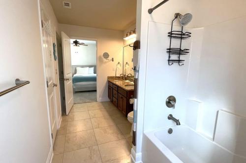 a bathroom with a tub and a toilet and a sink at Grayling Beach House in Inlet Beach