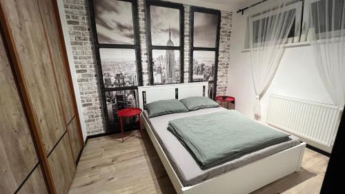 a bedroom with a bed with a brick wall at Lake apartment, 2x free garage, 10 mins to centre in Bratislava