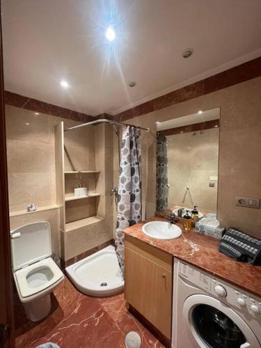 a bathroom with a sink and a toilet and a sink at Central Suites Poli Sanz in Vigo