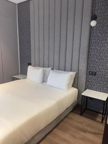 a bedroom with a bed with white pillows at Magic Appartement Luxury Gauthier 04 in Casablanca
