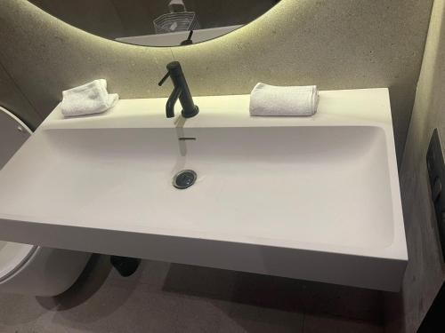 a white sink in a bathroom with a mirror at Magic Appartement Luxury Gauthier 04 in Casablanca