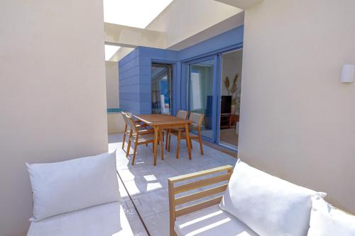 a dining room with a table and chairs on a patio at Casas do Forte Wood 6pax Piscina Privativa by Portugal Hideaway in Tavira