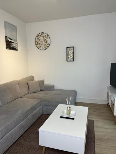 a living room with a couch and a coffee table at Maison Floirac Arkea Arena in Floirac