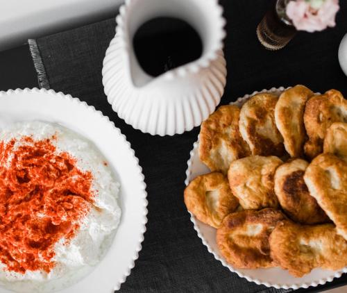 a table with two plates of food and a cup of coffee at Boutique Hotel HOH in Zagreb
