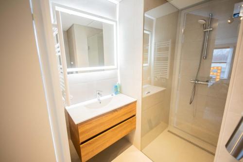 a bathroom with a sink and a shower at Alphabet Studio Apartments including City view in Hilversum