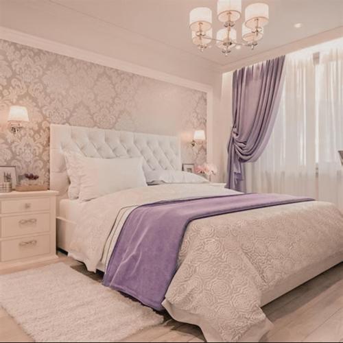 a bedroom with a large bed and a chandelier at DoodFamily77 