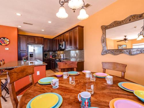 a kitchen with a wooden table with plates on it at El Dorado Ranch San Felipe Beach Condo 73-3 in La Ponderosa