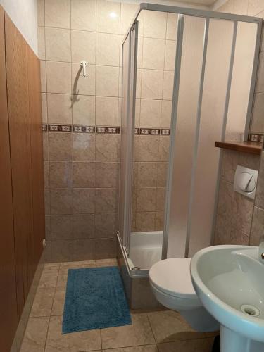 y baño con ducha, aseo y lavamanos. en Apartment Vila Marianna en Tatranská Polianka