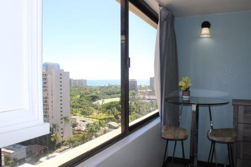 a room with a large window with a table and stools at Hawaiian Monarch 2010 condo in Honolulu