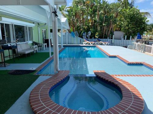 a swimming pool with a brick path around it at Oceanview home on Indian Rocks Beach in Clearwater Beach