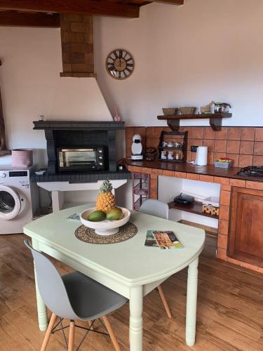 a kitchen with a table with a bowl of fruit on it at CASITA LAS VISTAS in Frontera