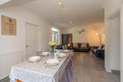 a living room with a table with plates on it at Dwellcome Home Ltd 5 Bed 2 and half Bath Aberdeen House - see our site for assurance in Aberdeen