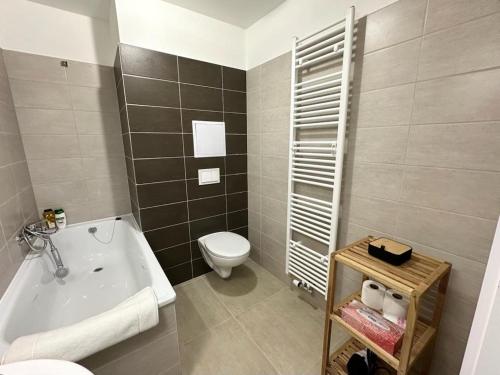 a bathroom with a toilet and a bath tub at Sky Apartments 511 in Plzeň