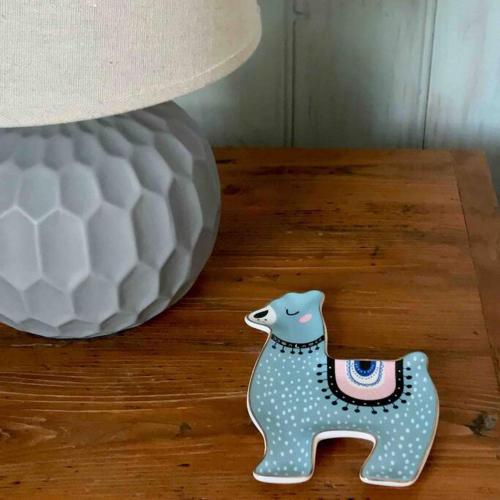 a vase and a figurine on a table next to a lamp at Alyeska Loft - Apollo Bay studio loft apartment in Apollo Bay