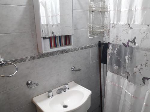 uma casa de banho com um lavatório e um espelho em Departamentos Don Carlos em Villa Cura Brochero