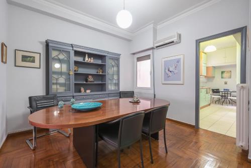 a dining room with a table and chairs at Andromar in the heart of Kolonaki in Athens