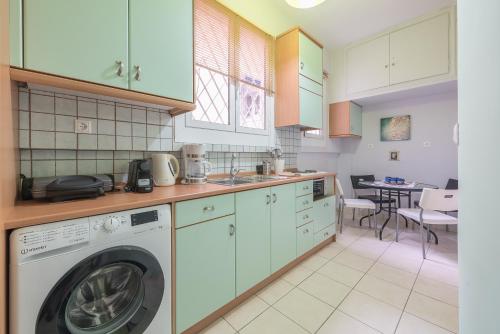 a kitchen with a washer and a dishwasher at Andromar in the heart of Kolonaki in Athens