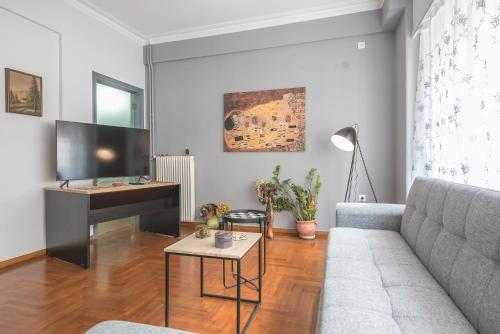 a living room with a couch and a piano at Andromar in the heart of Kolonaki in Athens