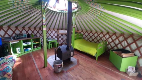 a interior of a yurt with a stove in it at La Bohémienne des yourtes du petit ruisseau in Mandeville